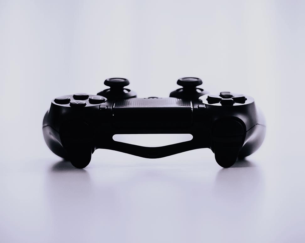 A black video game controller to depict the topic of consumer electronics